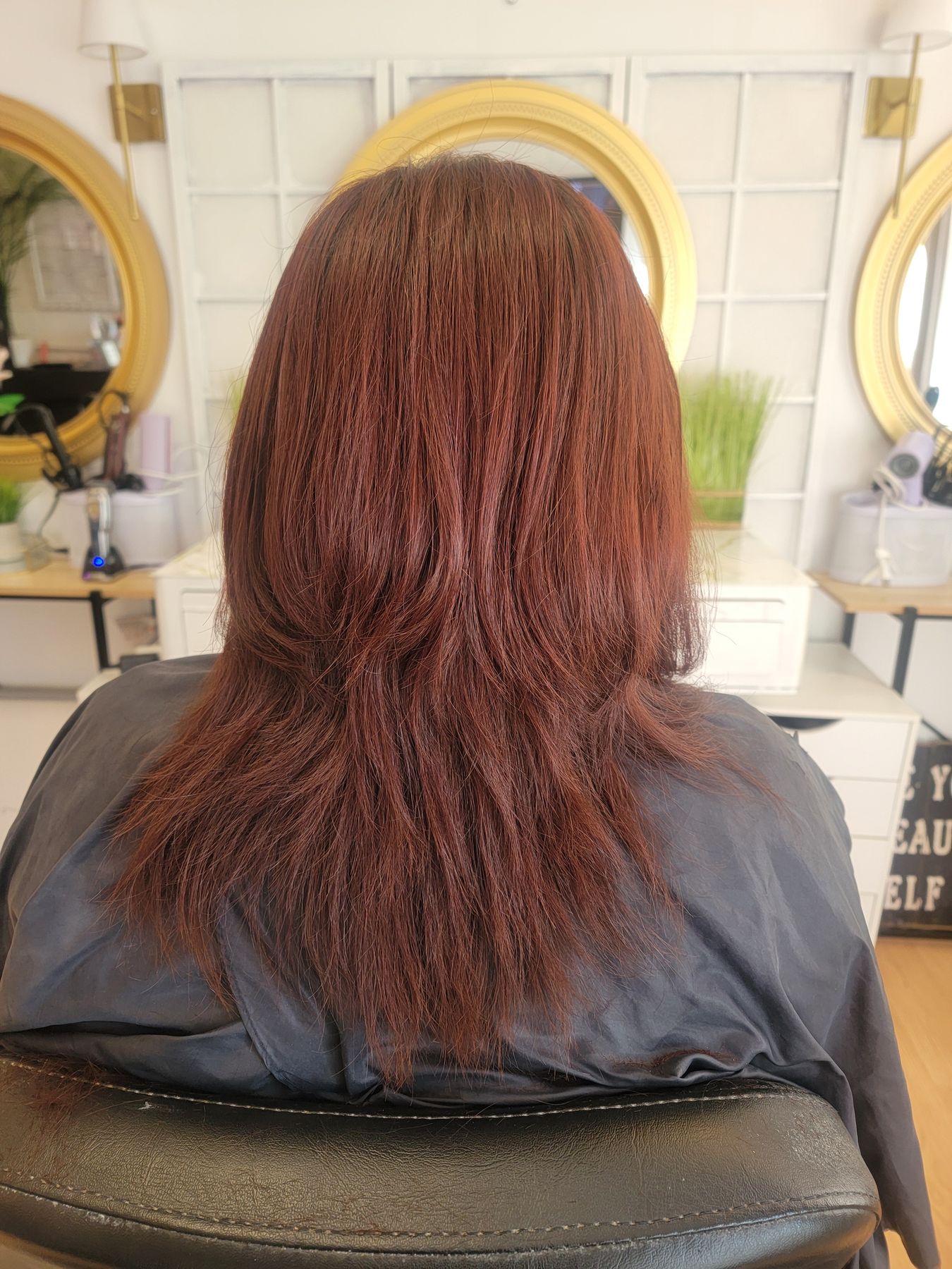 Deep auburn colour on long layered hair