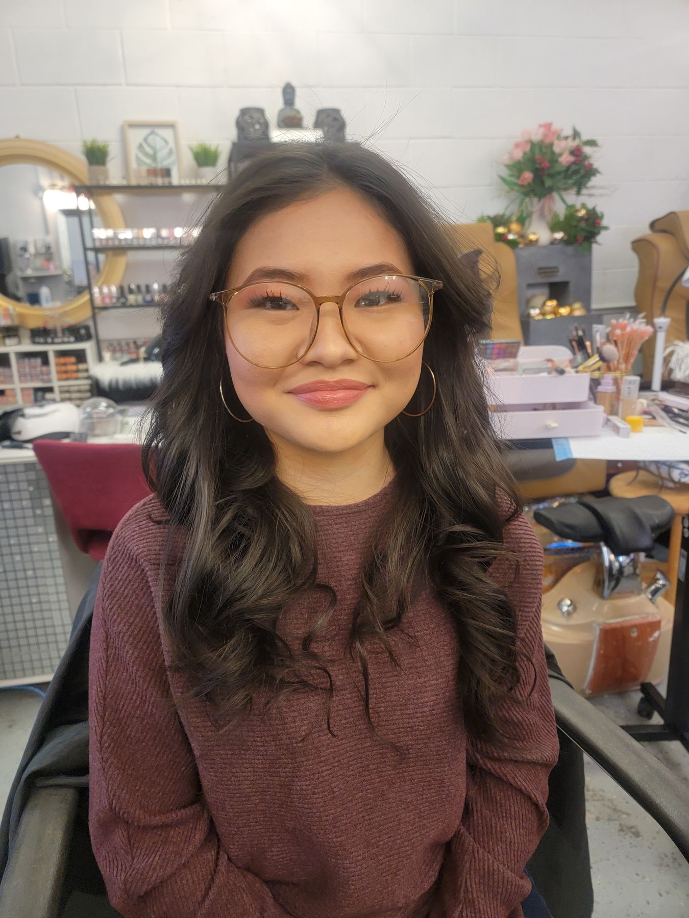 Client smiling with fresh soft curls at JasBeauty