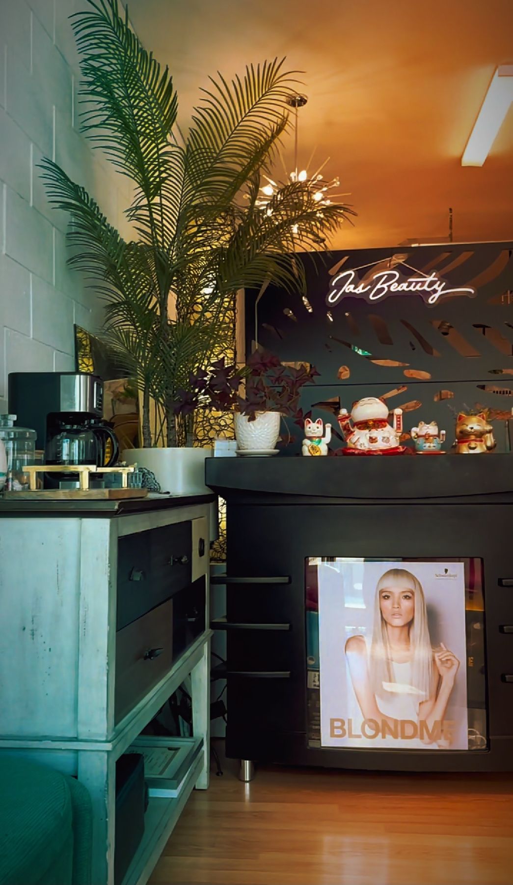 JasBeauty's neon sign glowing over the front desk