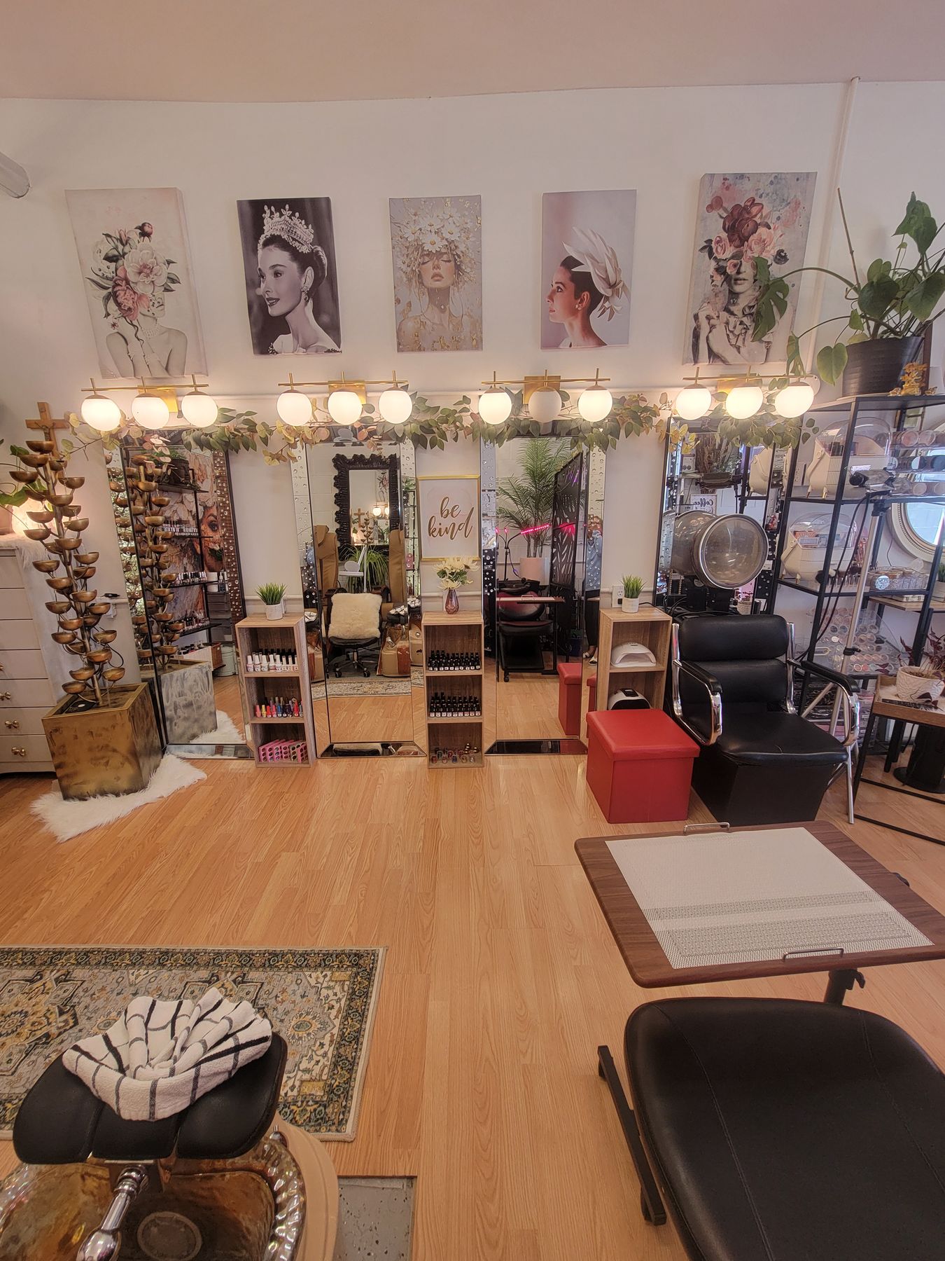 Wide view of the salon floor with mirrors and portrait art