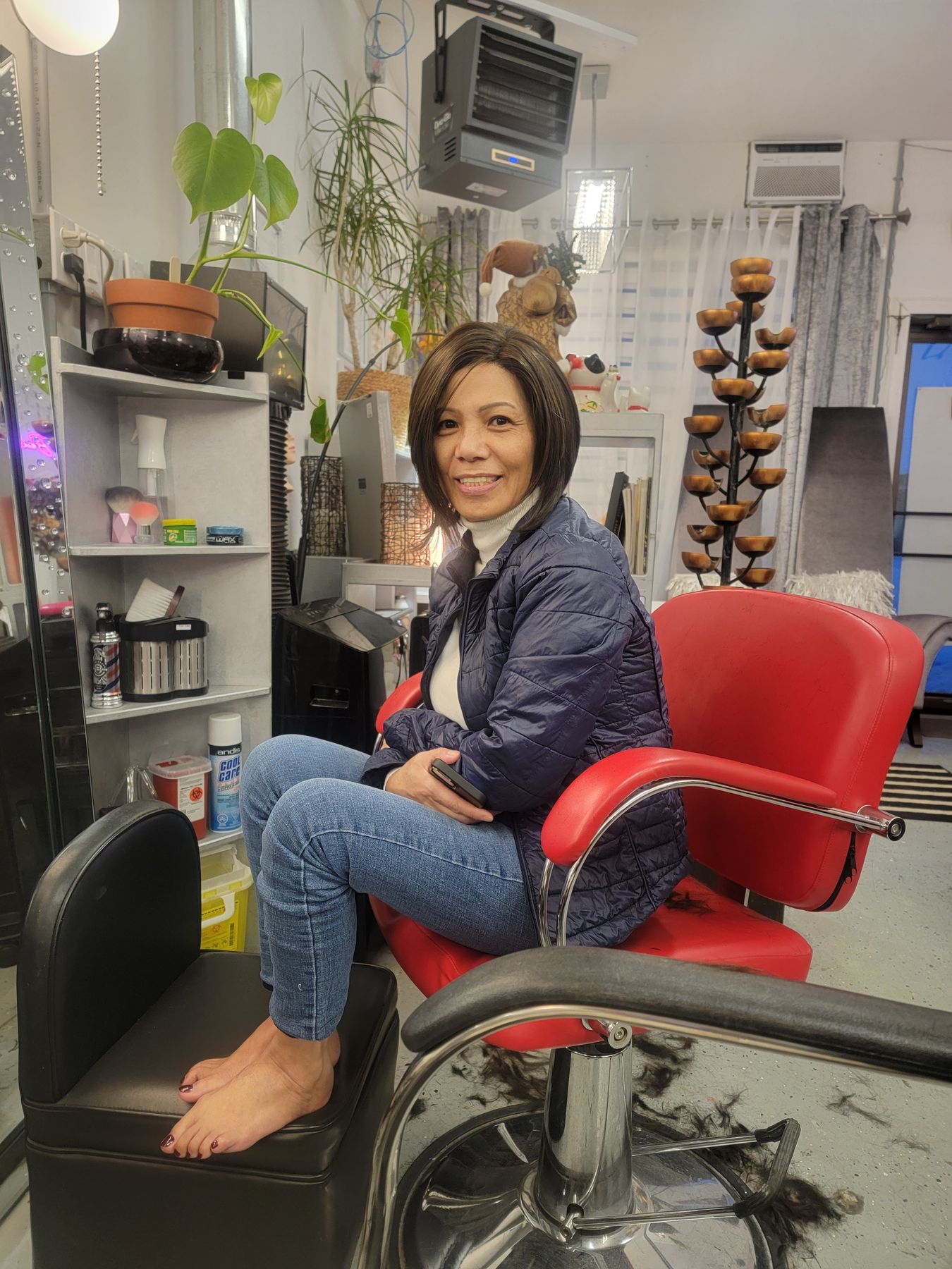 The red styling chair on the salon floor