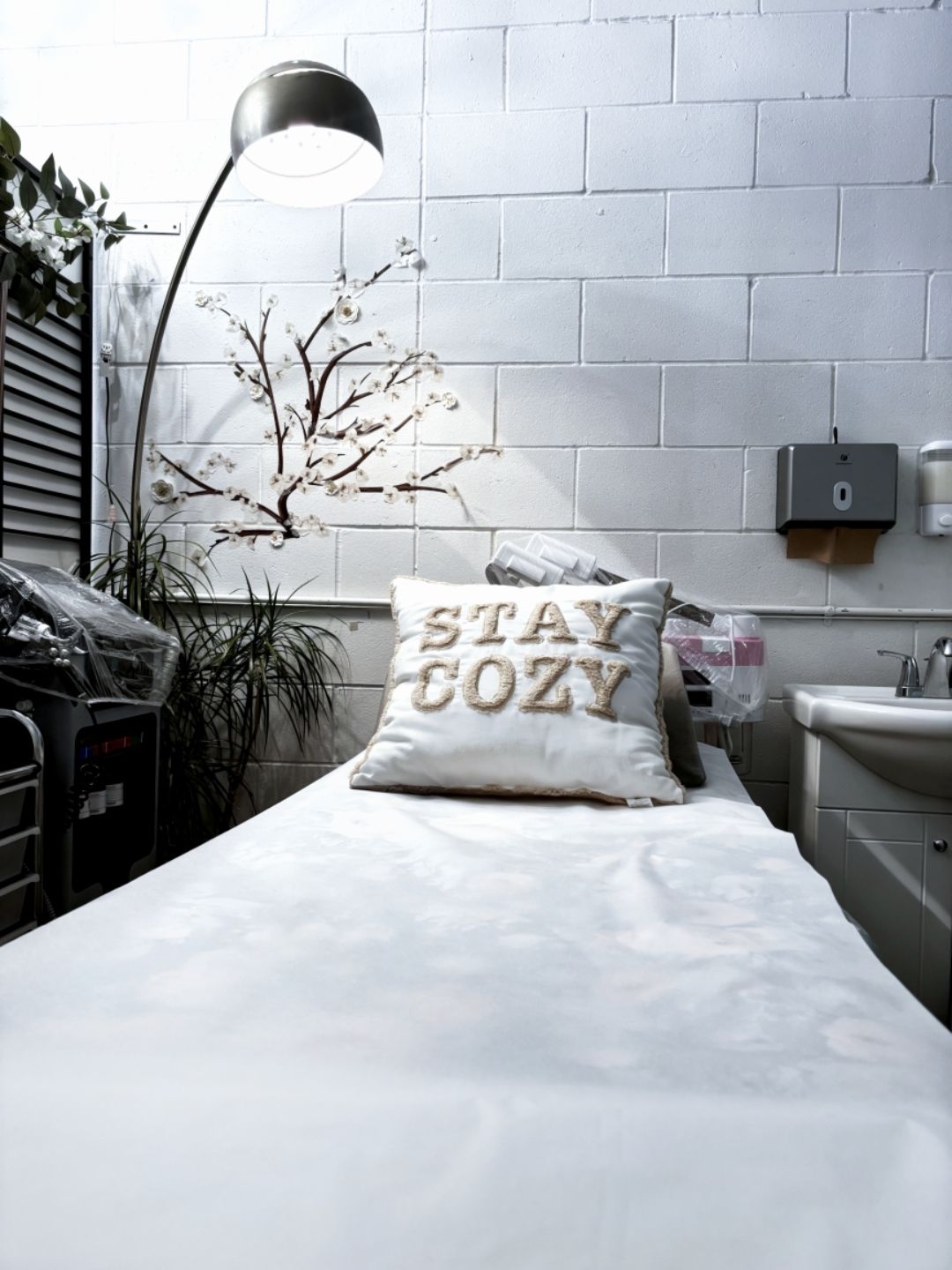 White spa bed with a Stay Cozy pillow