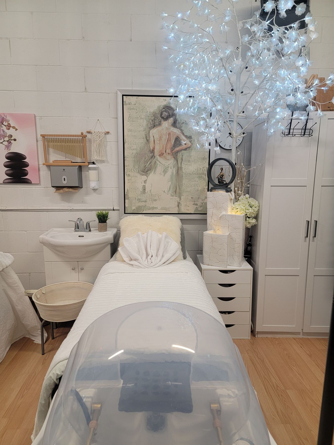 Spa bed with treatment dome beside pale wardrobes