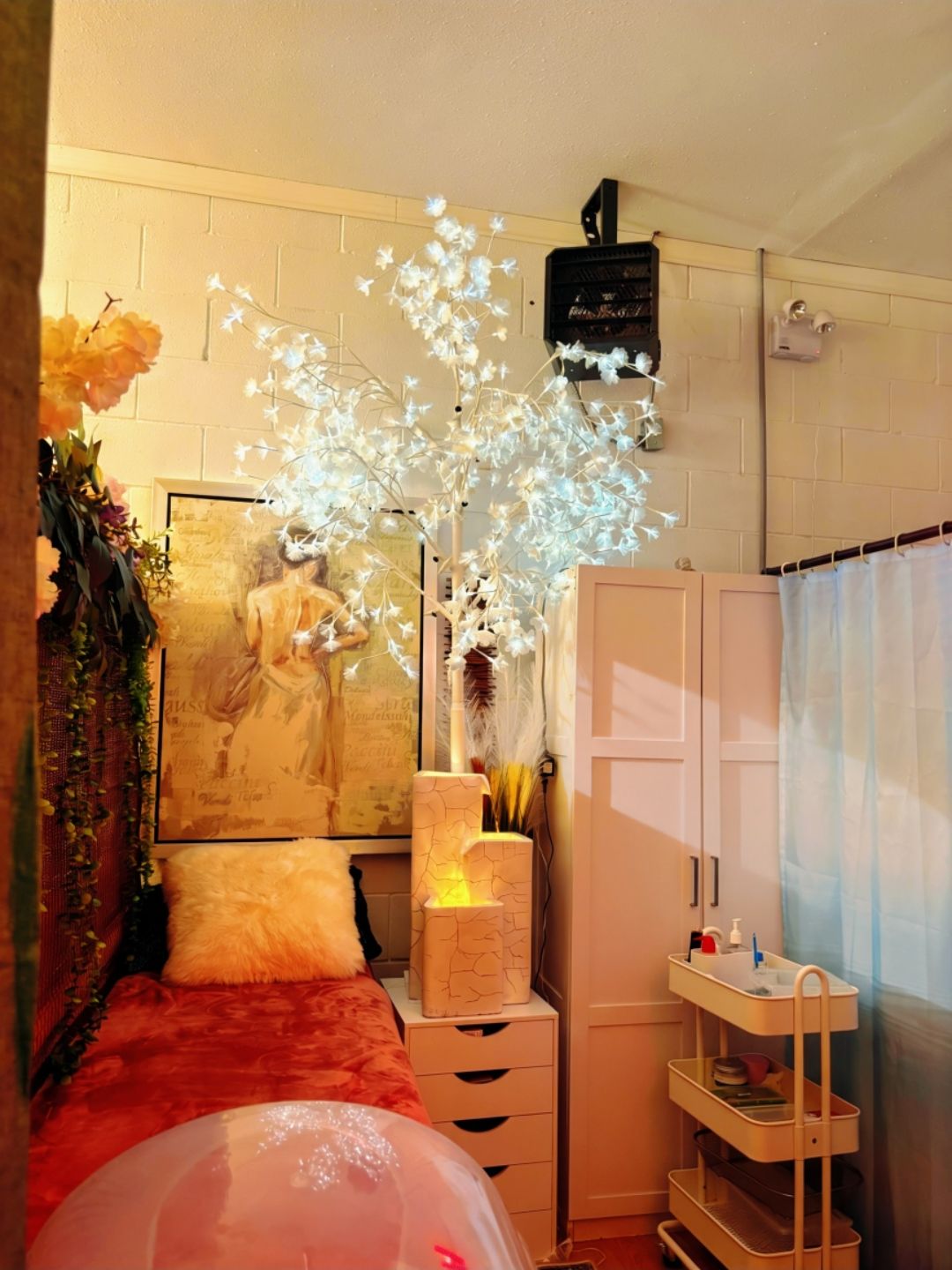 Warmly lit spa room with a glowing blossom tree