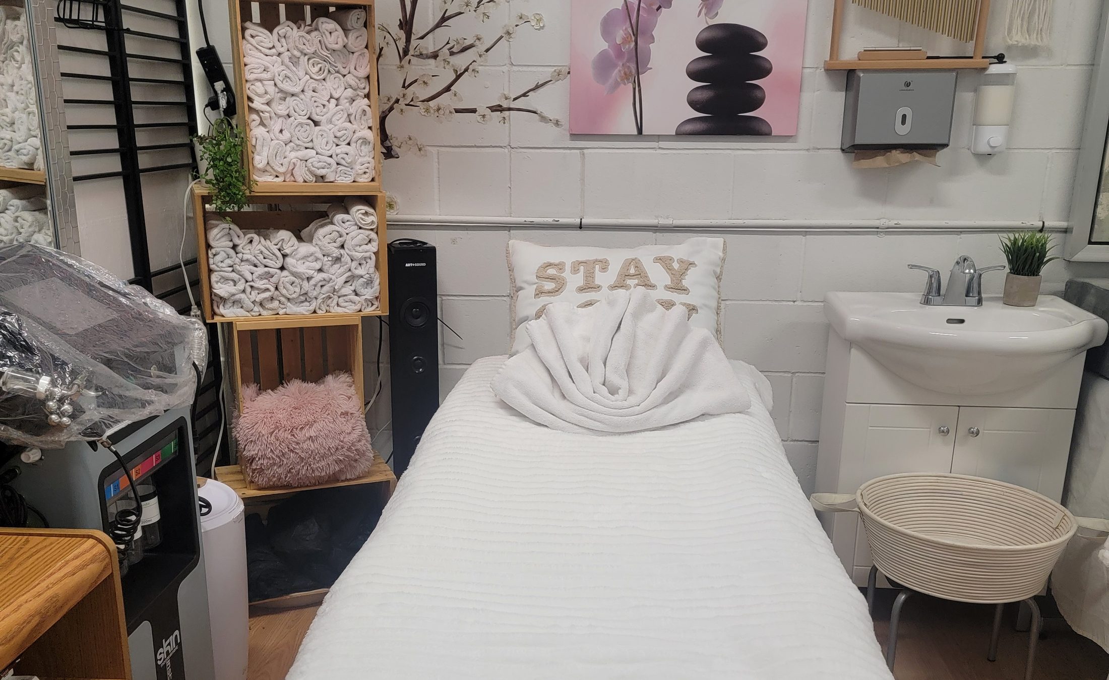 JasBeauty's massage table dressed in white with warm towels