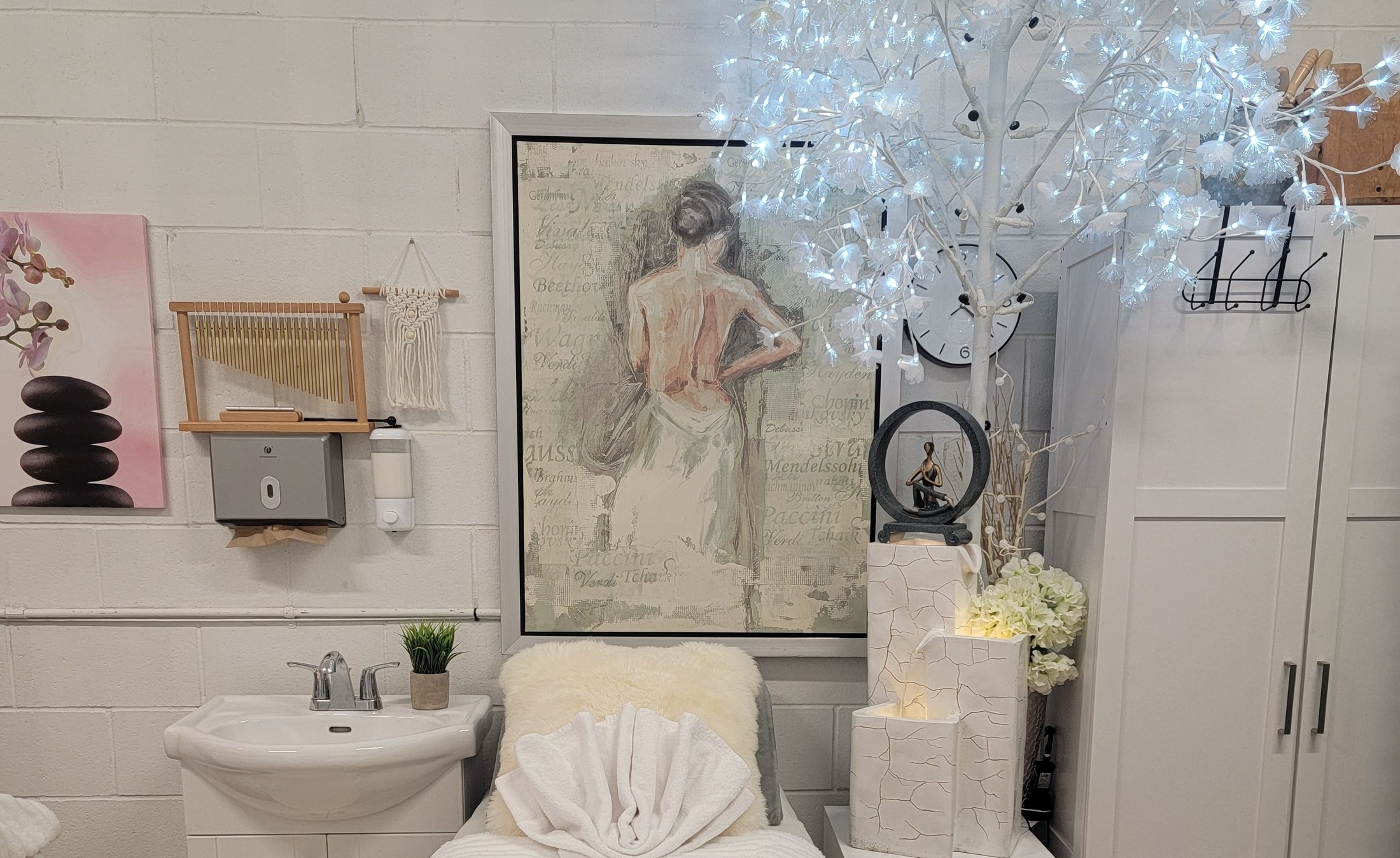 JasBeauty's white spa room with a lit blossom tree